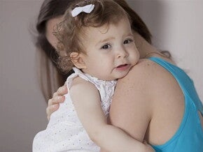 Mamá abrazando a niña pequeña que llora