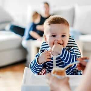 Guía para darle alimentos sólidos a tu bebé Bebé en su silla comiendo alimentos sólidos